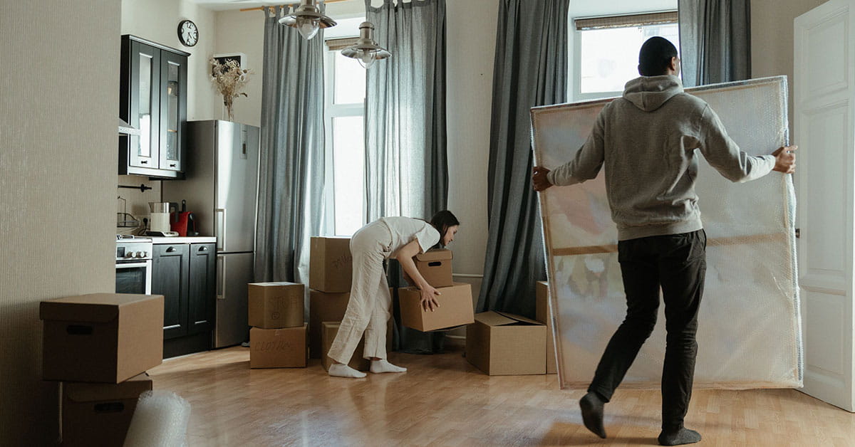 Woman checking clipboard near boxes
